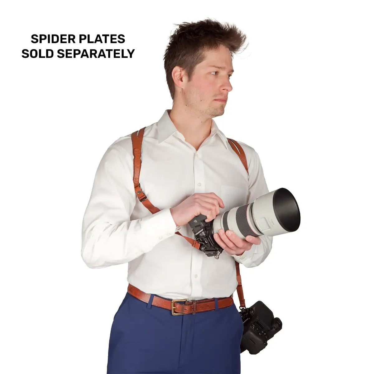 Man holding a camera with a lens, wearing suspenders, on a white background with text 'SPIDER PLATES SOLD SEPARATELY'.