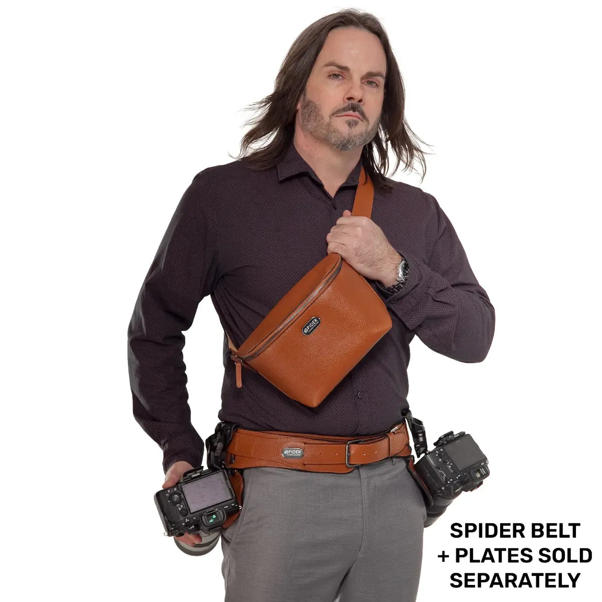 Man wearing a brown leather belt with a holster, holding a camera, on a white background.