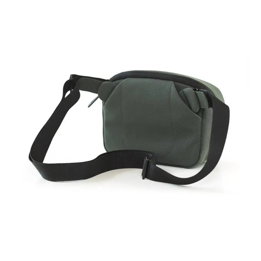 Green waist bag with a black strap on a white background