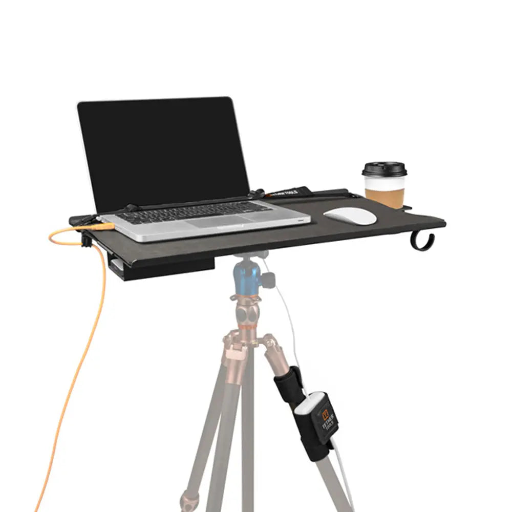 Portable desk attached to a tripod with a laptop and coffee cup on a white background