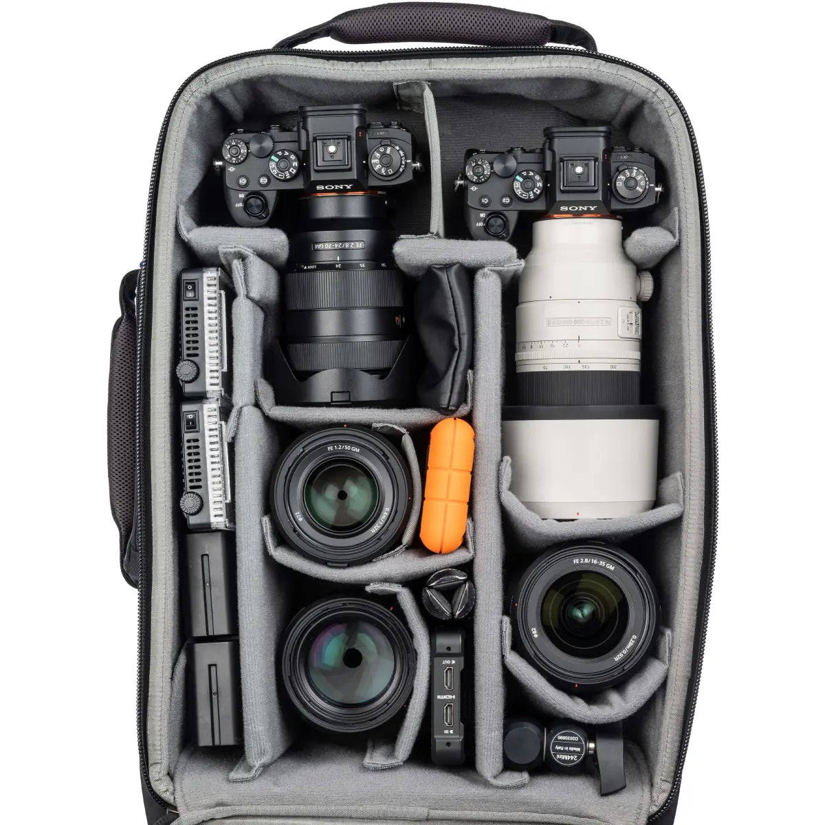 Camera bag with camera equipment including lenses and a camera body.