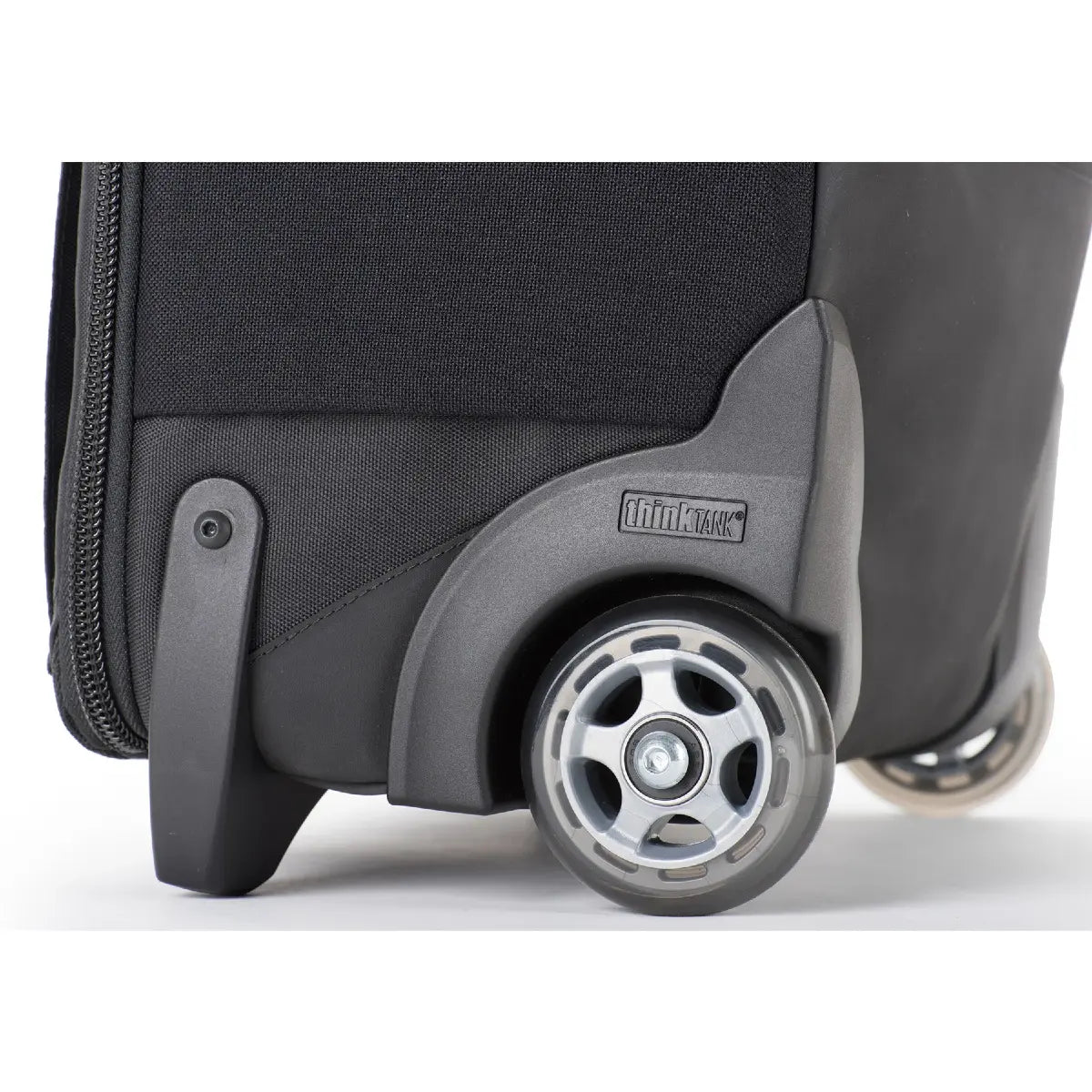 Close-up of a suitcase wheel on a white background