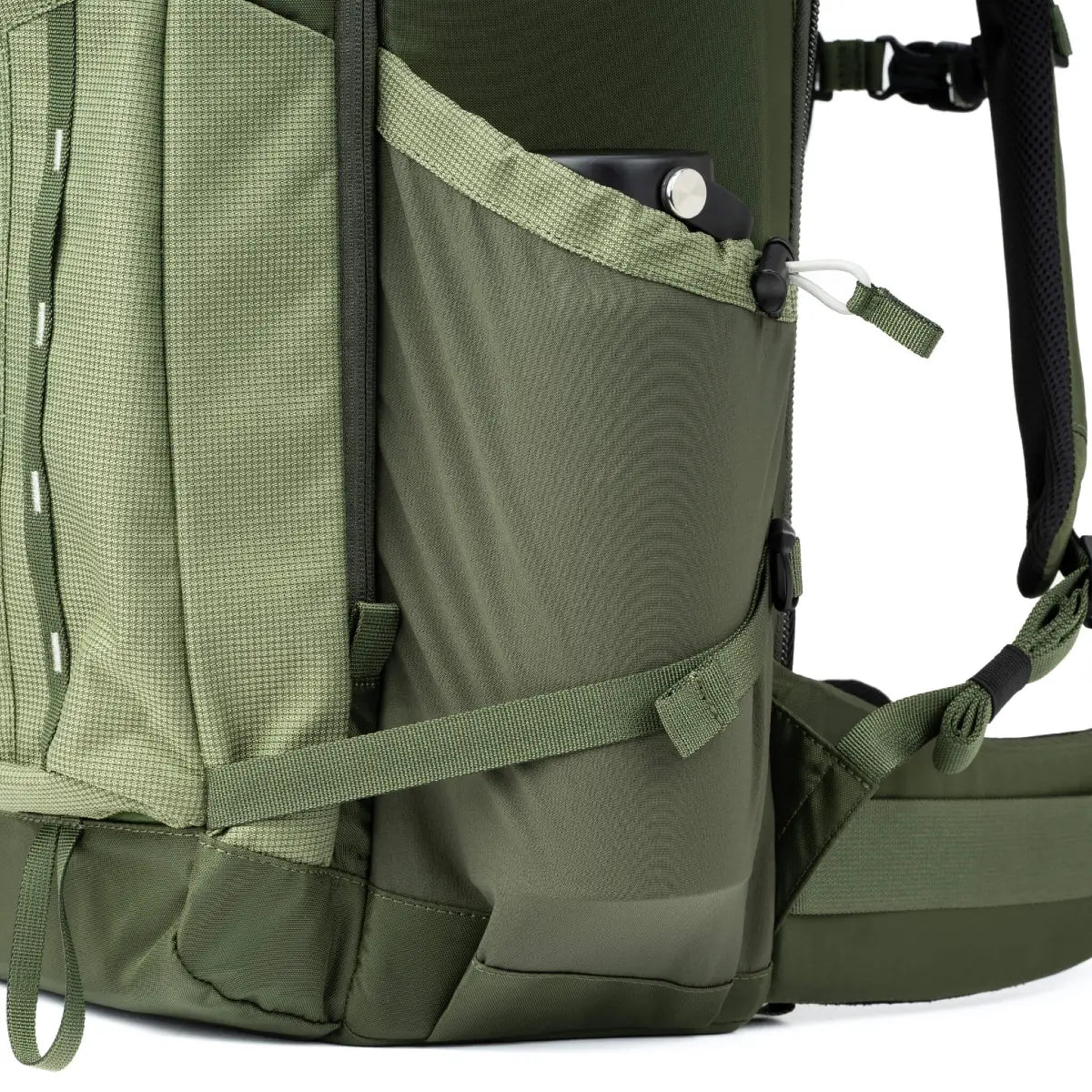 Close-up of a green backpack with straps and zippers on a white background
