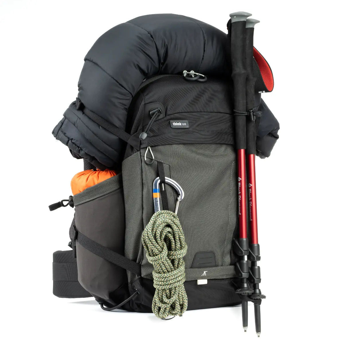 Hiking backpack with trekking poles and rope on a white background