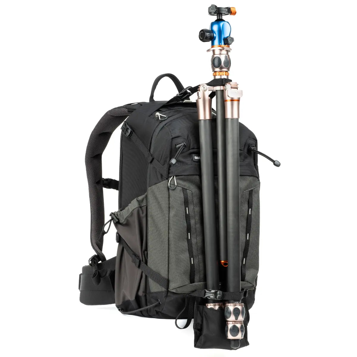 Black backpack with camera equipment including a tripod and camera on a white background