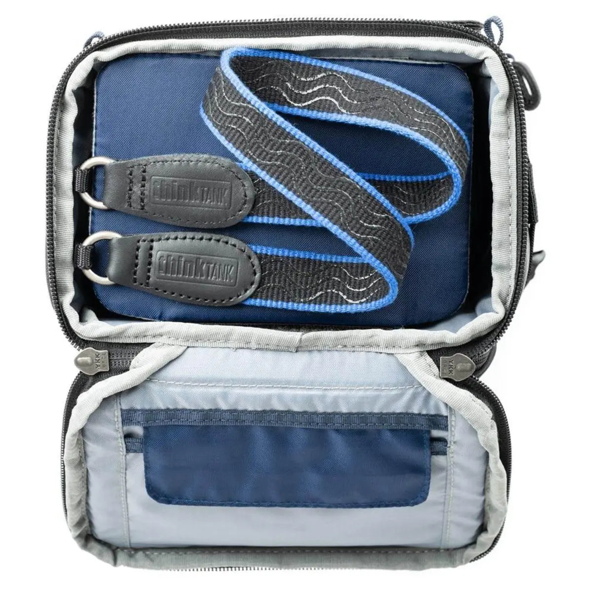Open travel bag with straps and blue interior on a white background