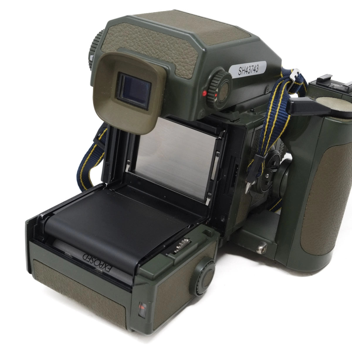 Green camera with open film back on a white background