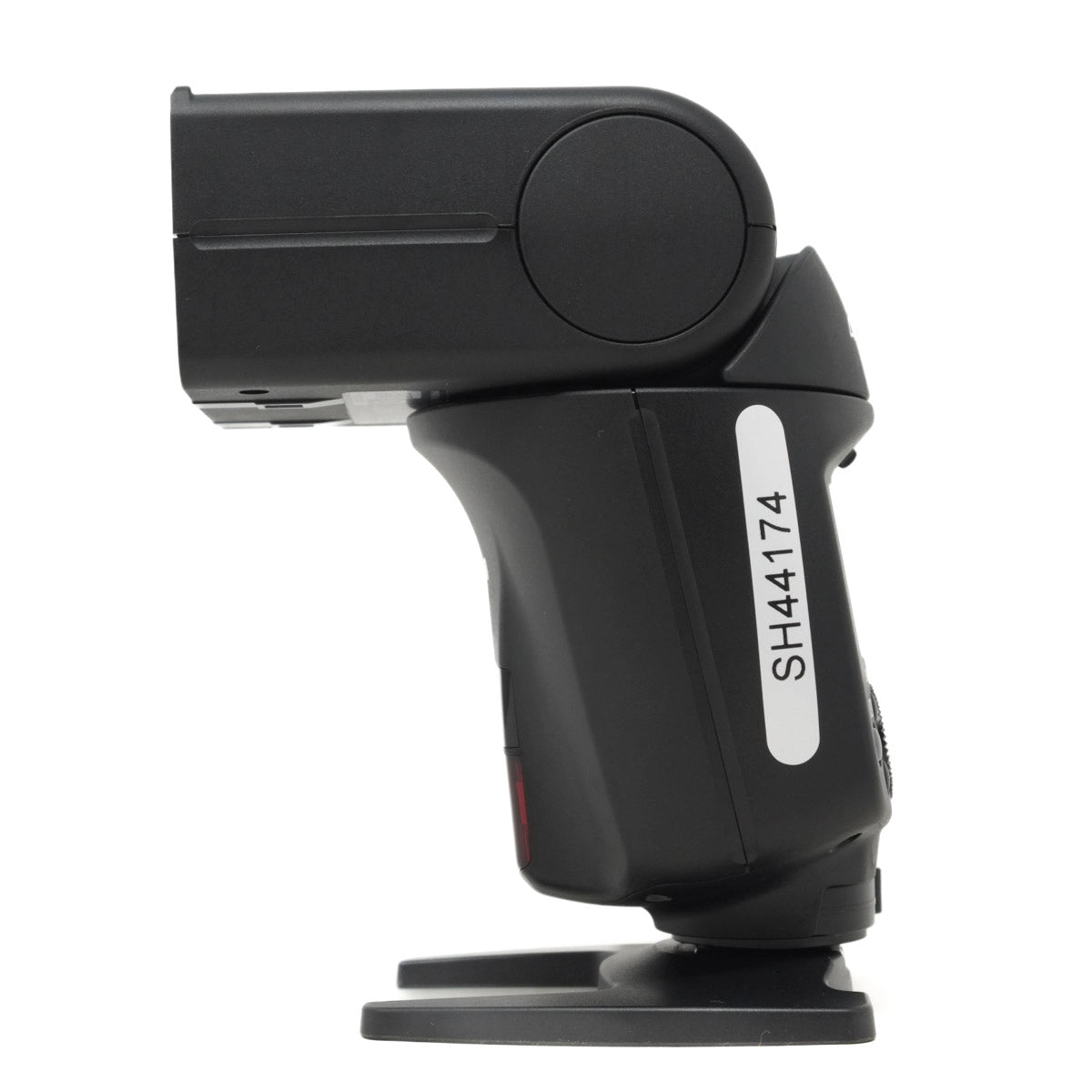 Black camera flash with a label on a white background