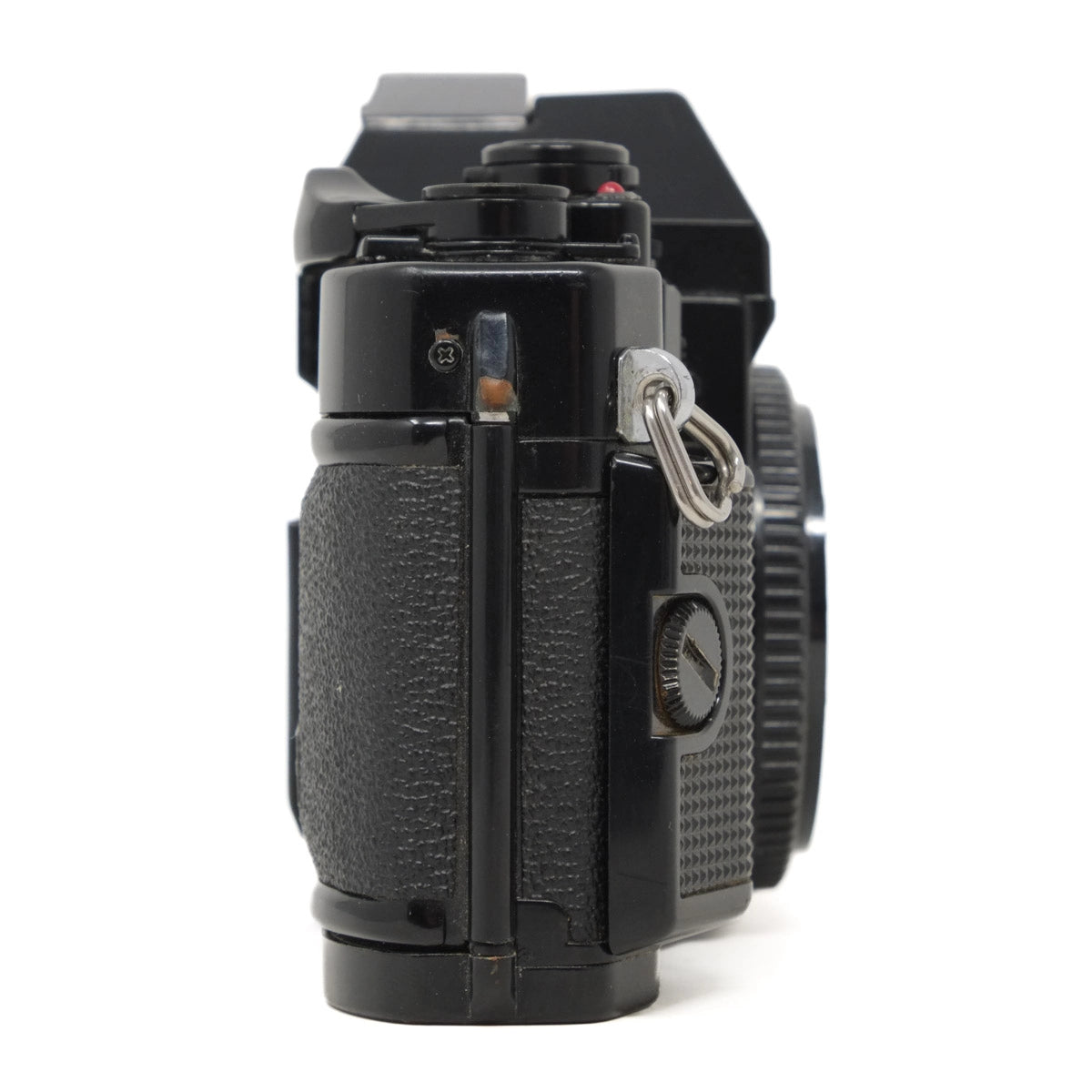 Black camera body with body cap on a white background