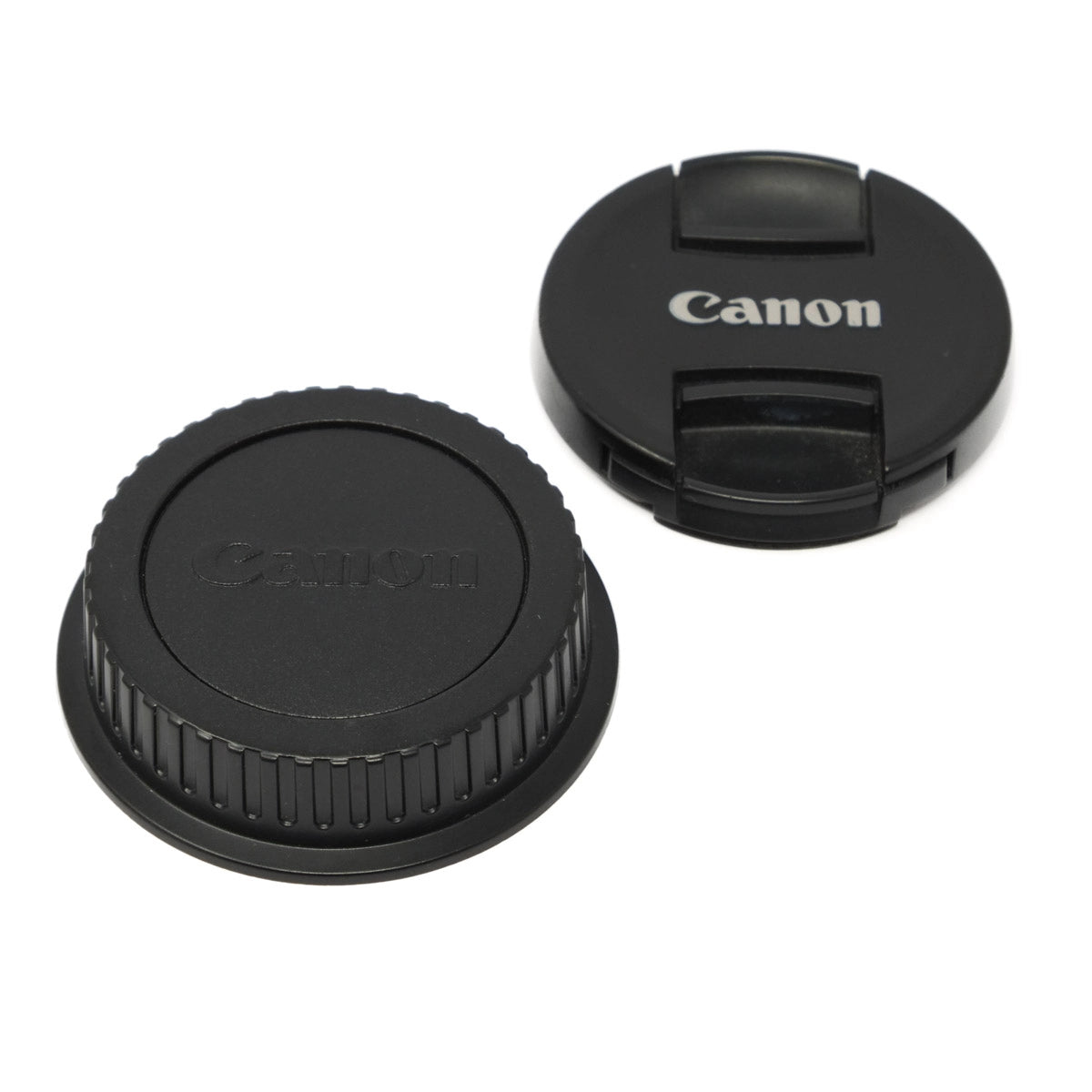 Two Canon lens caps on a white background
