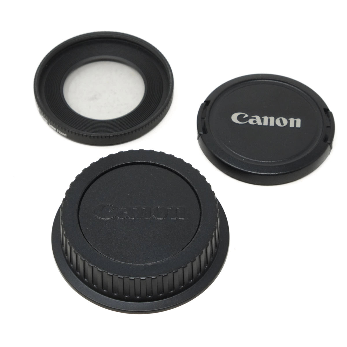 Canon camera lens accessories including a hood, front cap, and rear cap on a white background.