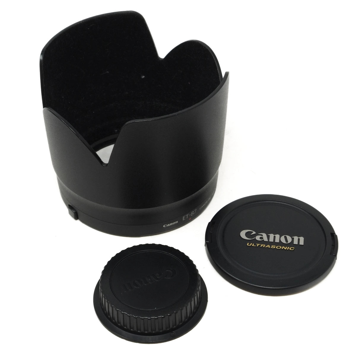 Canon lens hood and caps on a white background