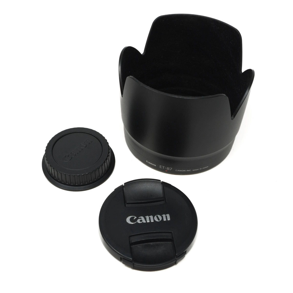 Canon lens hood and caps on a white background