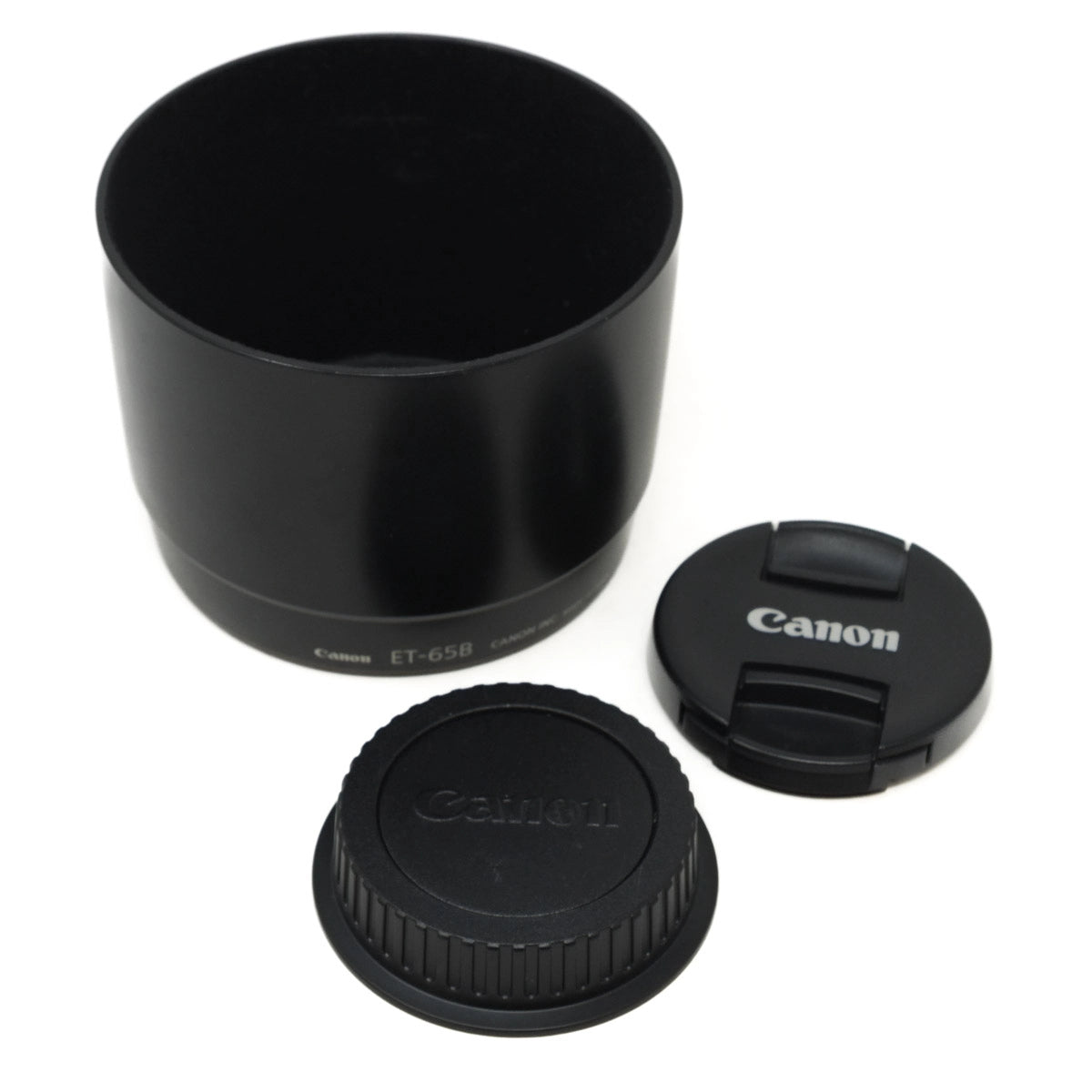 Canon lens hood and caps on a white background