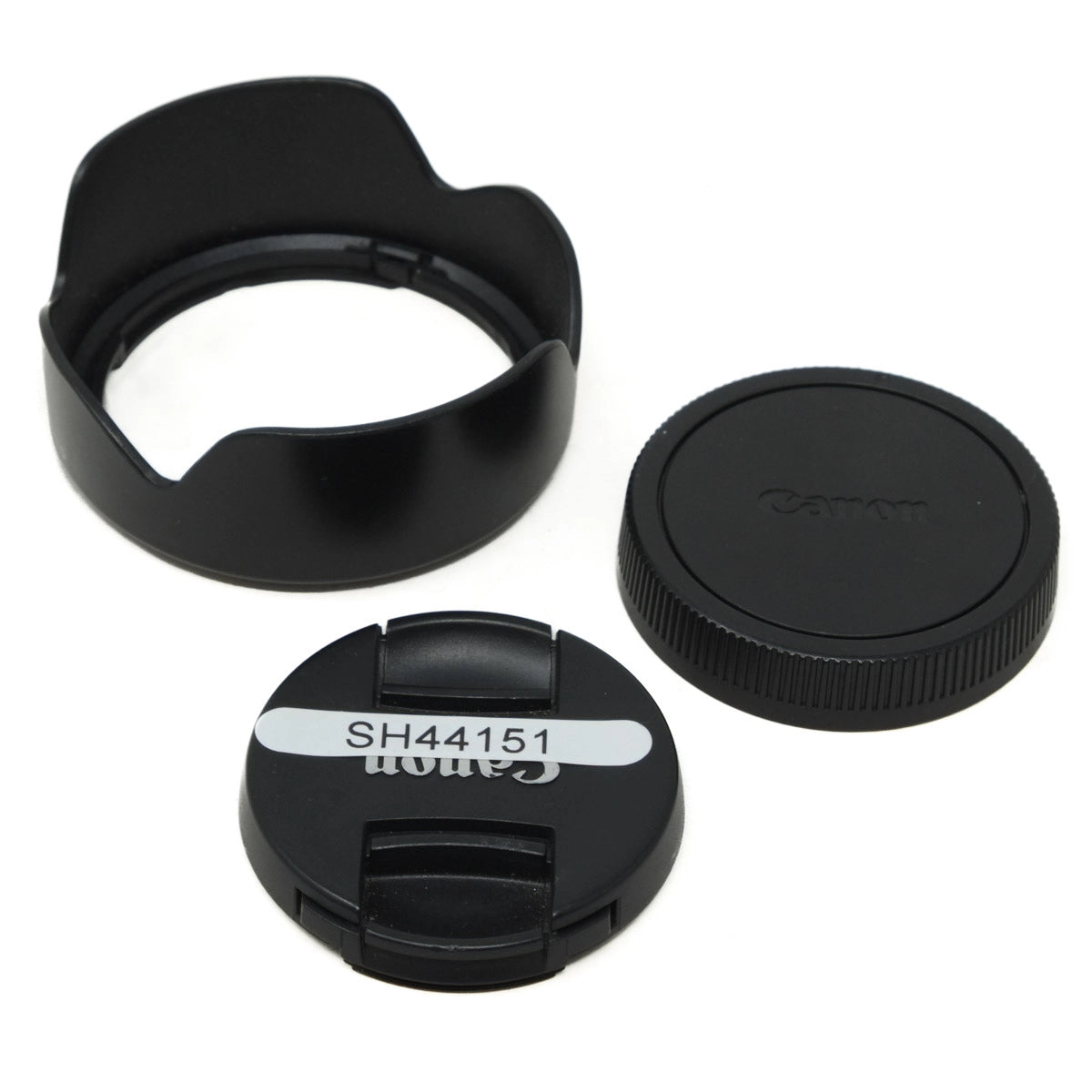 Camera lens cap, hood, and body cap on a white background