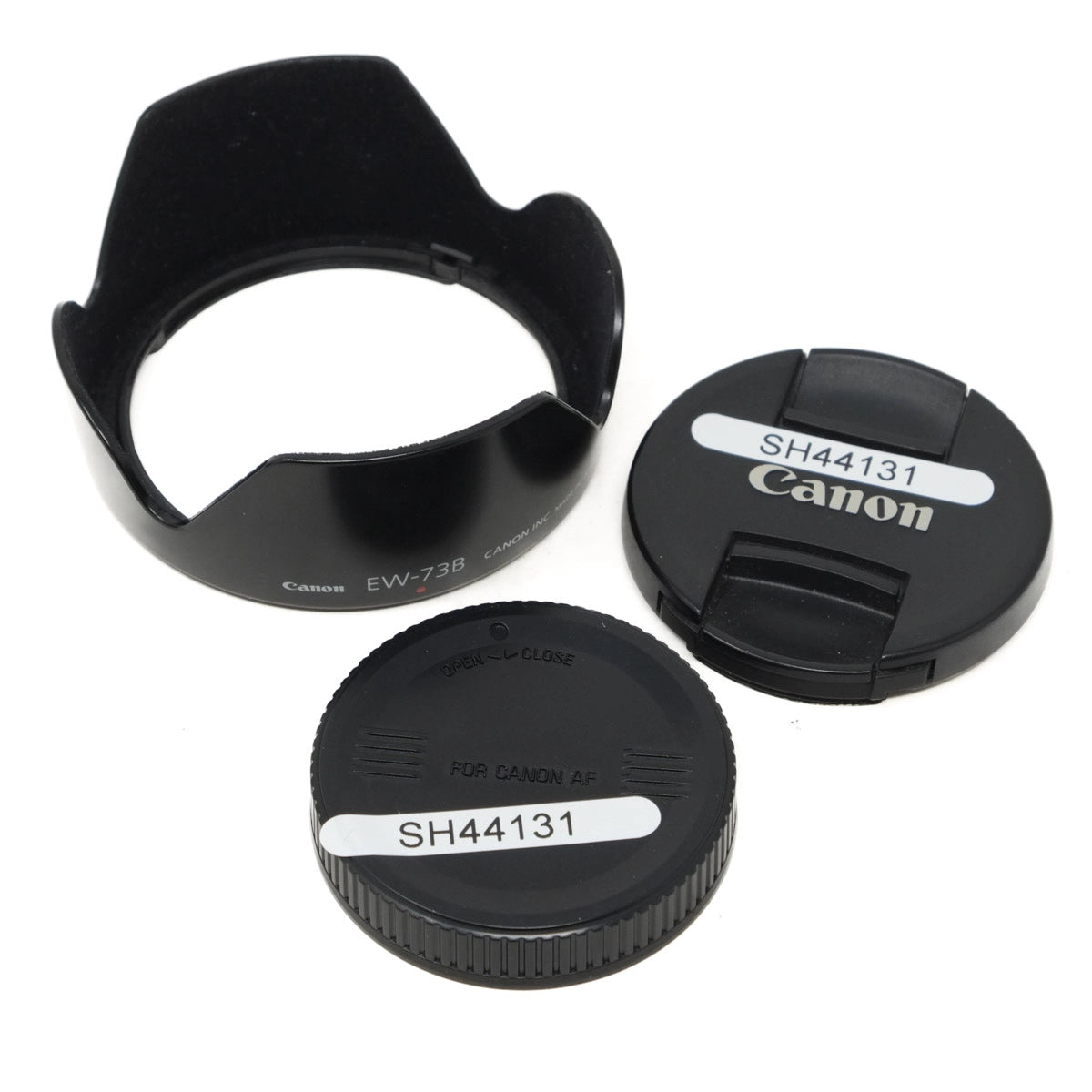 Canon lens caps and hood on a white background