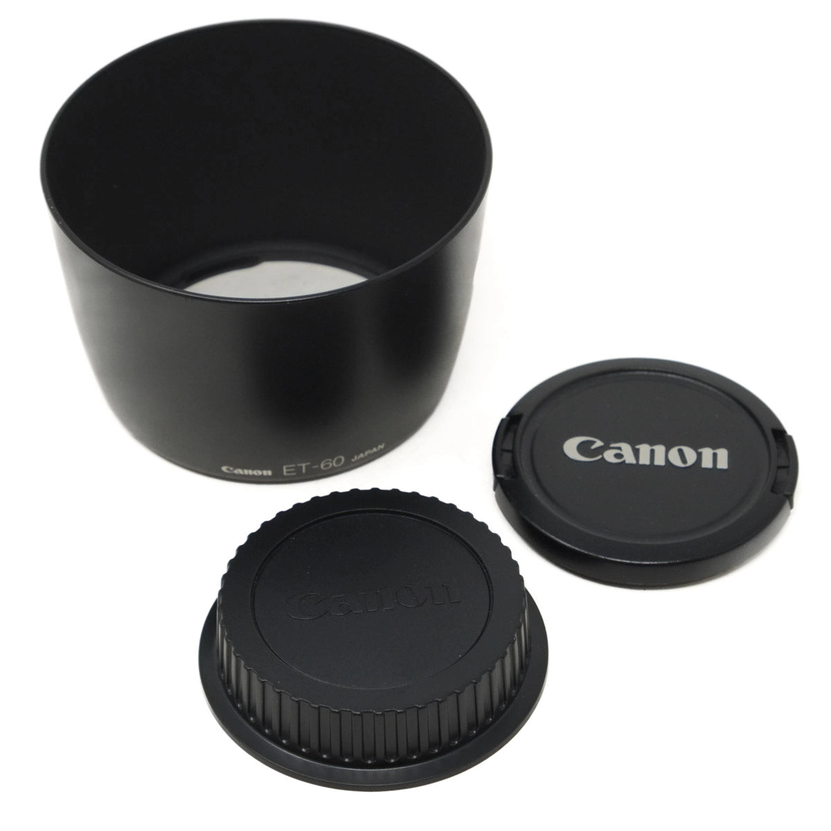 Canon lens hood and caps on a white background