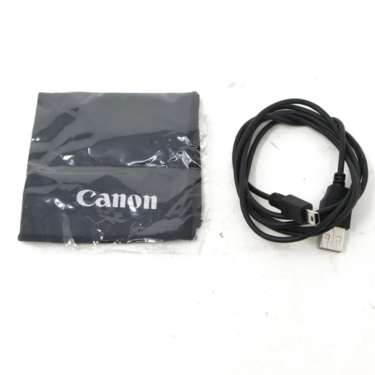 Used Canon EOS 100D + 18-55mm IS - cloth and cable