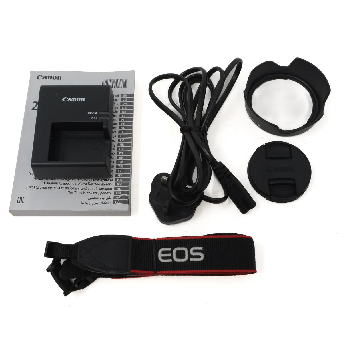 Canon EOS camera battery charger kit with a black battery charger, power cord, lens hood, lens cap, and EOS neck strap on a white background.