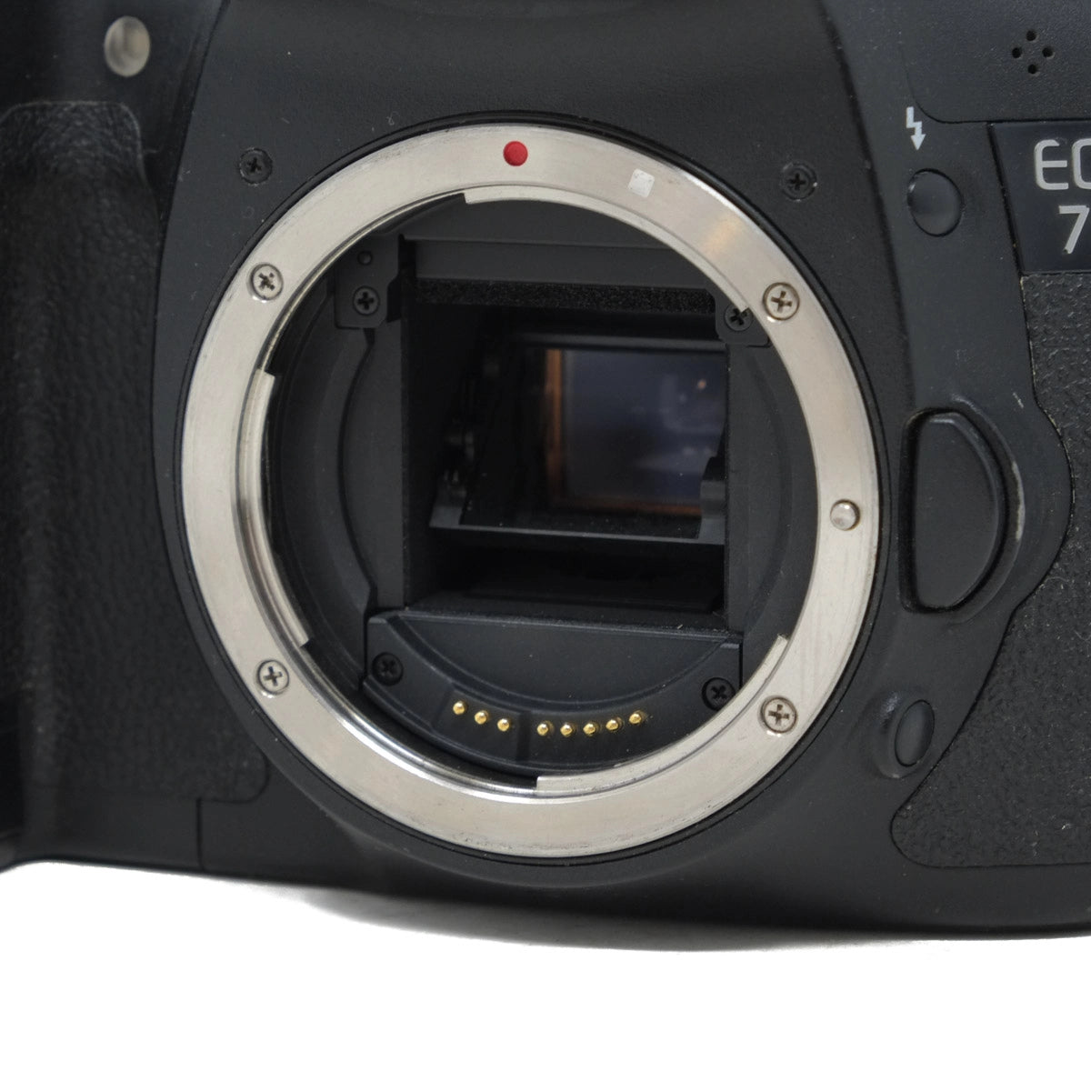 Close-up of a camera body without a lens on a white background