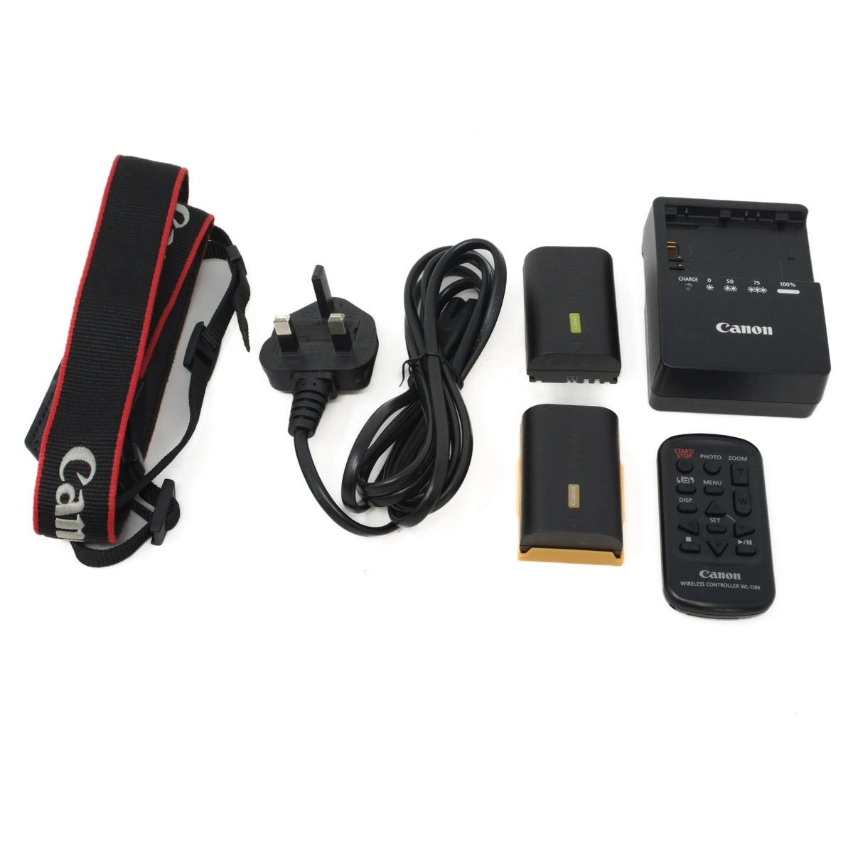 Canon camera accessories including strap, plug, cable, battery, charger, and remote control on a white background.