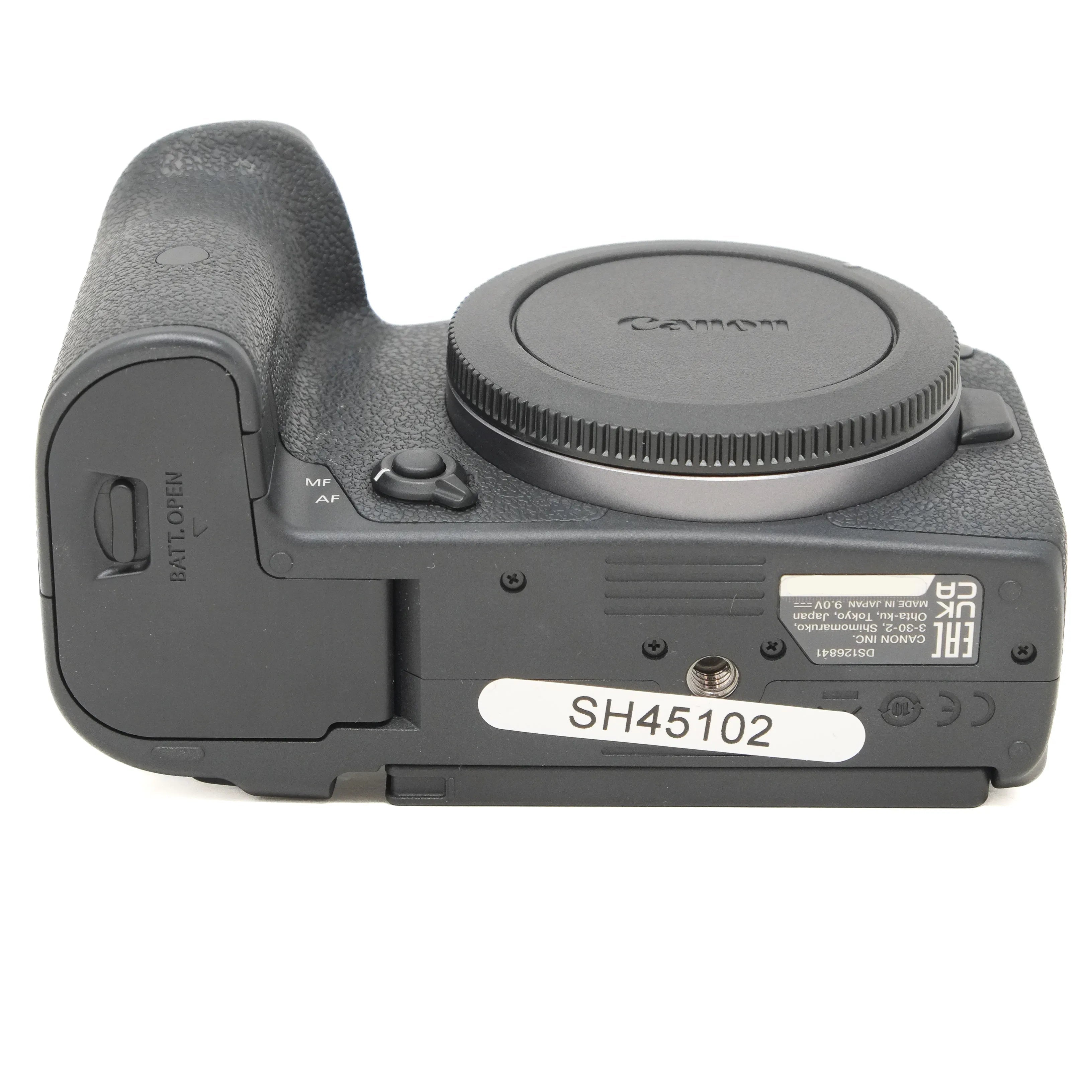 Camera body with body cap on a white background