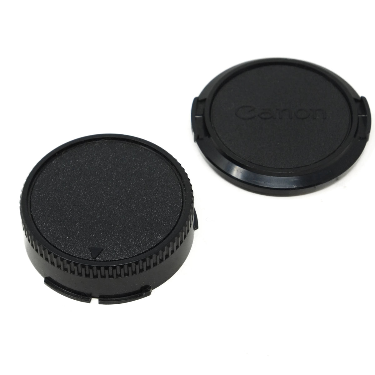 Two black camera lens caps, one with 'Canon' branding, on a white background.