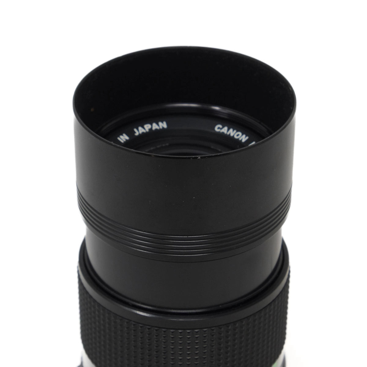 Black Canon camera lens hood on a white background