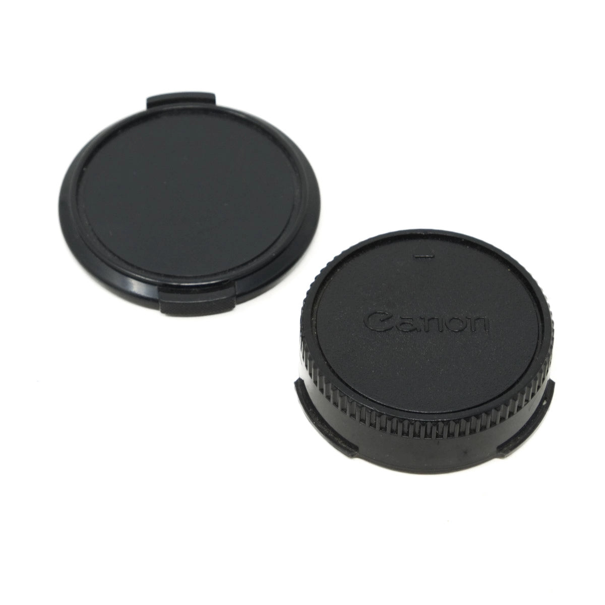 Canon lens caps on a white background