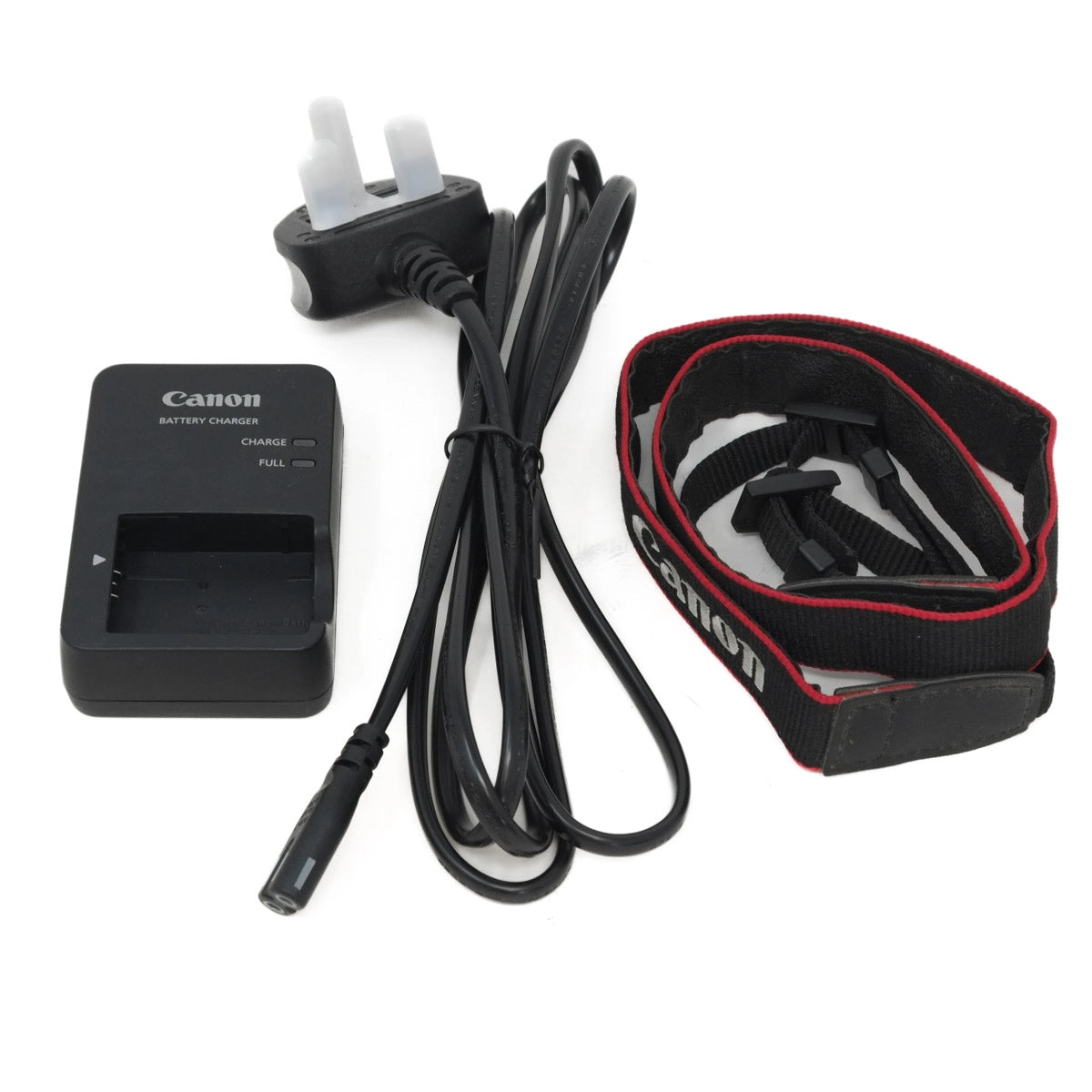 Canon battery charger, power adapter, and camera strap on a white background