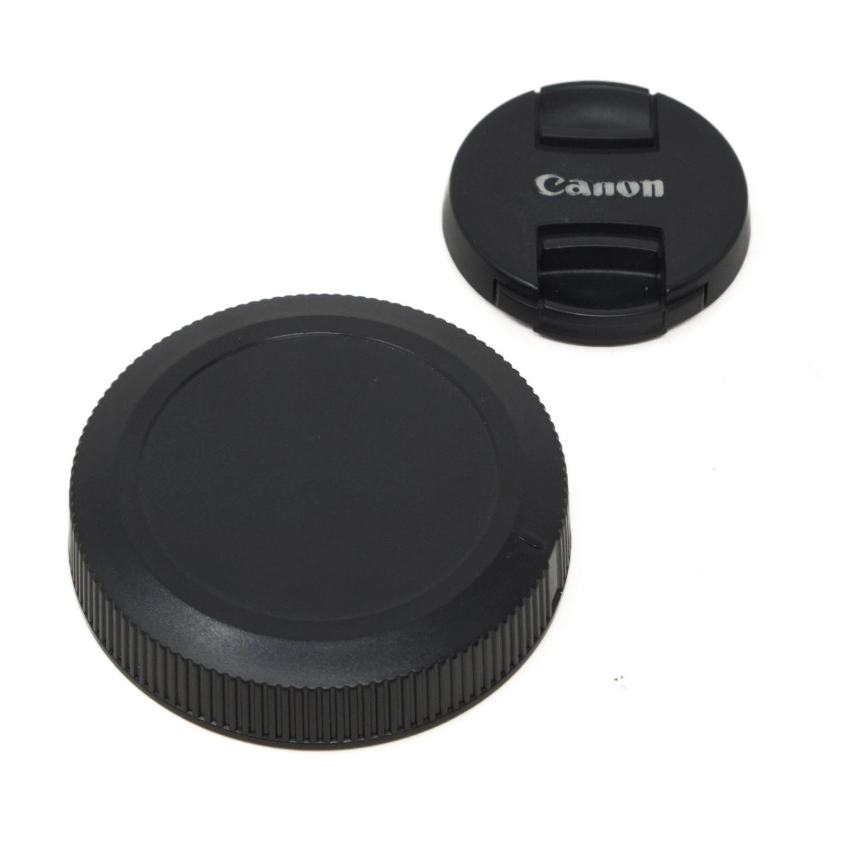 Canon camera lens caps on a white background