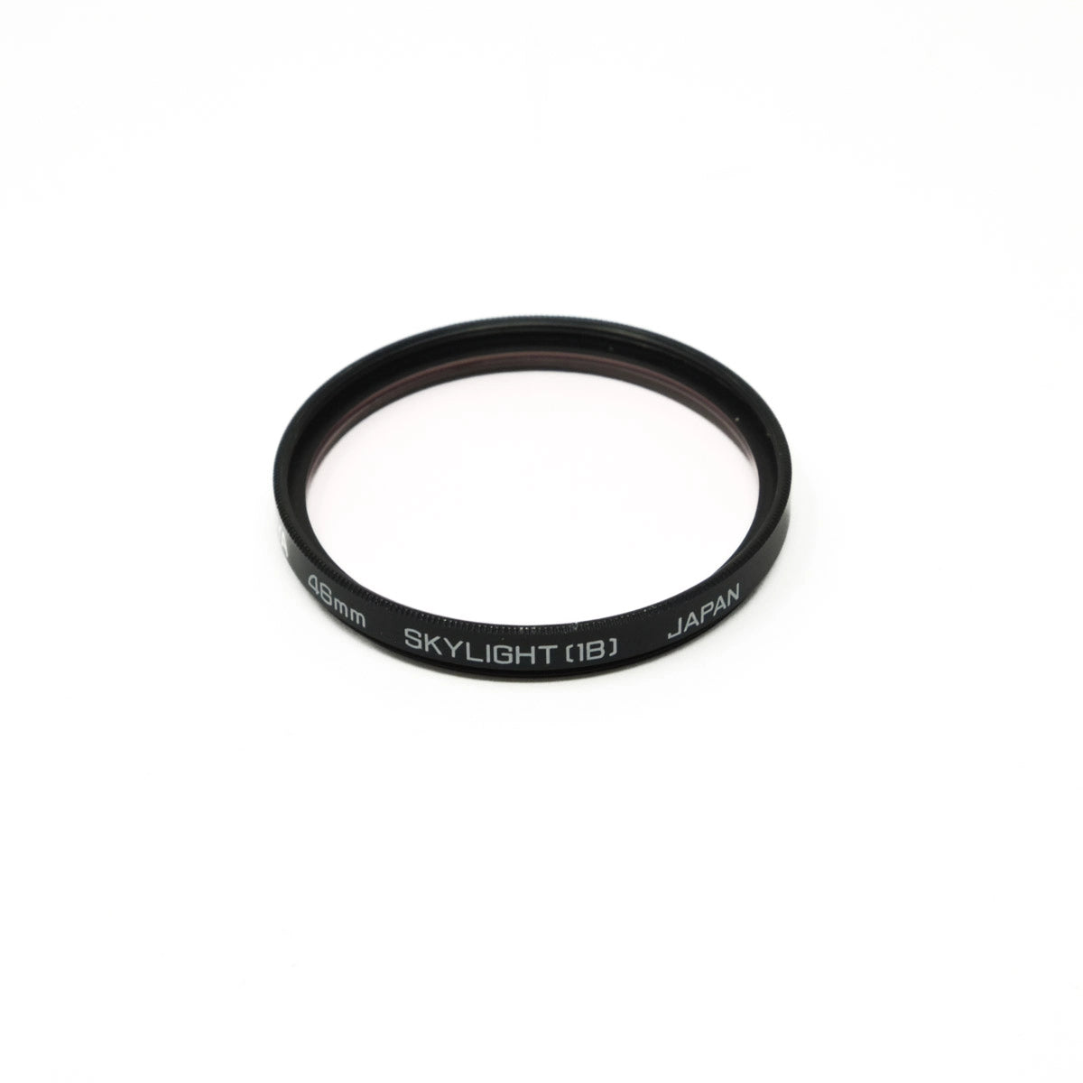 Black camera lens filter with 'Skylight (1B)' and 'Japan' text on a white background