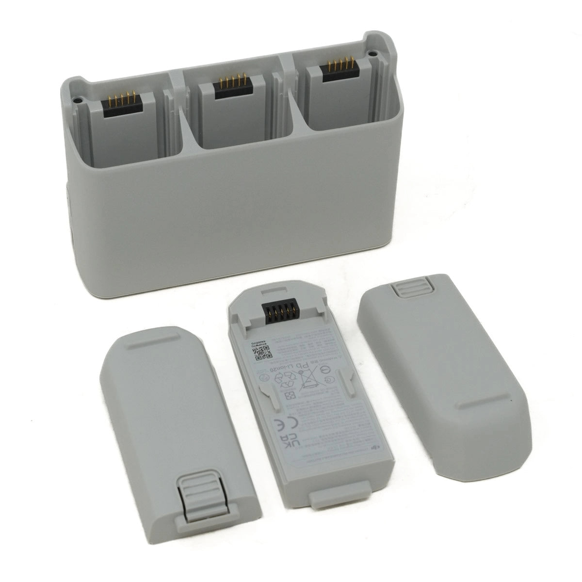 Gray battery charger and batteries on a white background