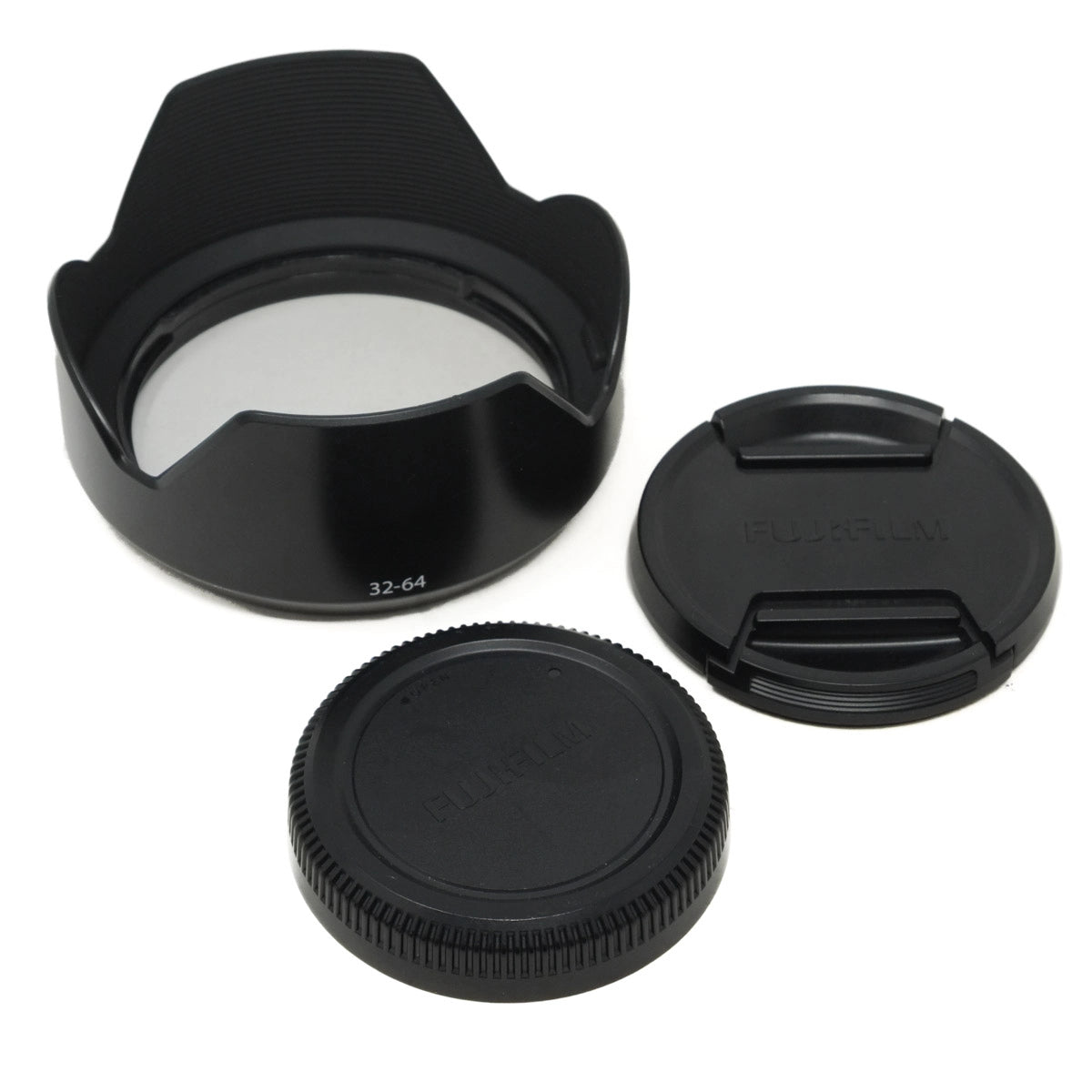 Set of black camera lens accessories including a lens hood, front and rear caps on a white background.