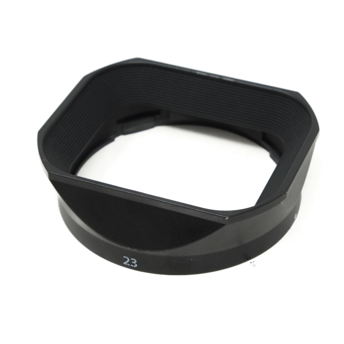 Black camera lens hood on a white background