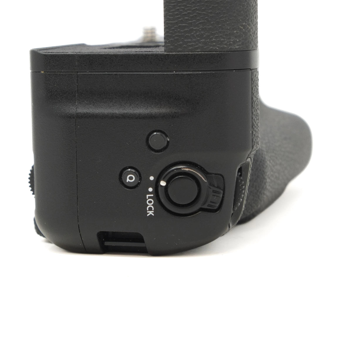 Close-up of a black camera grip with control buttons on a white background