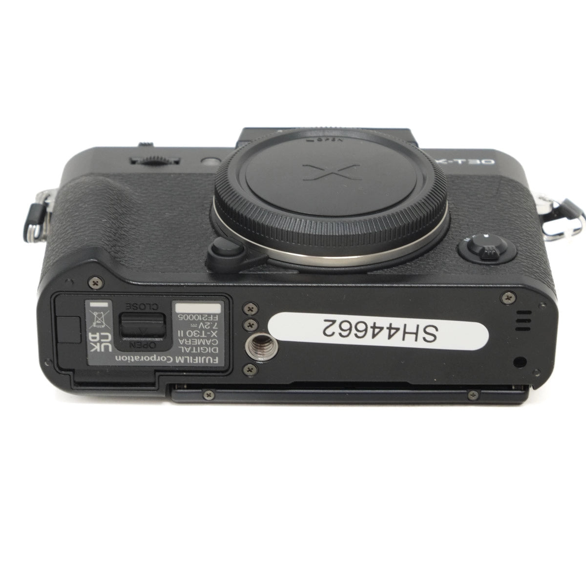 Bottom view of a black camera on a white background