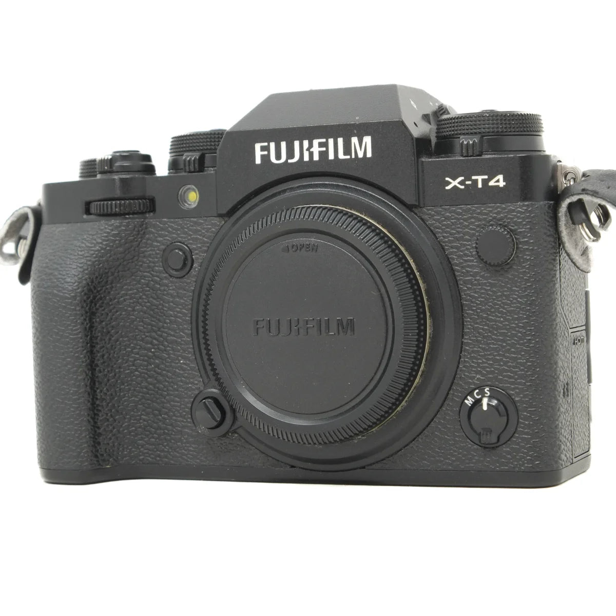 Fujifilm X-T4 mirrorless camera body in black, shown from the front with the body cap on, against a plain white background.