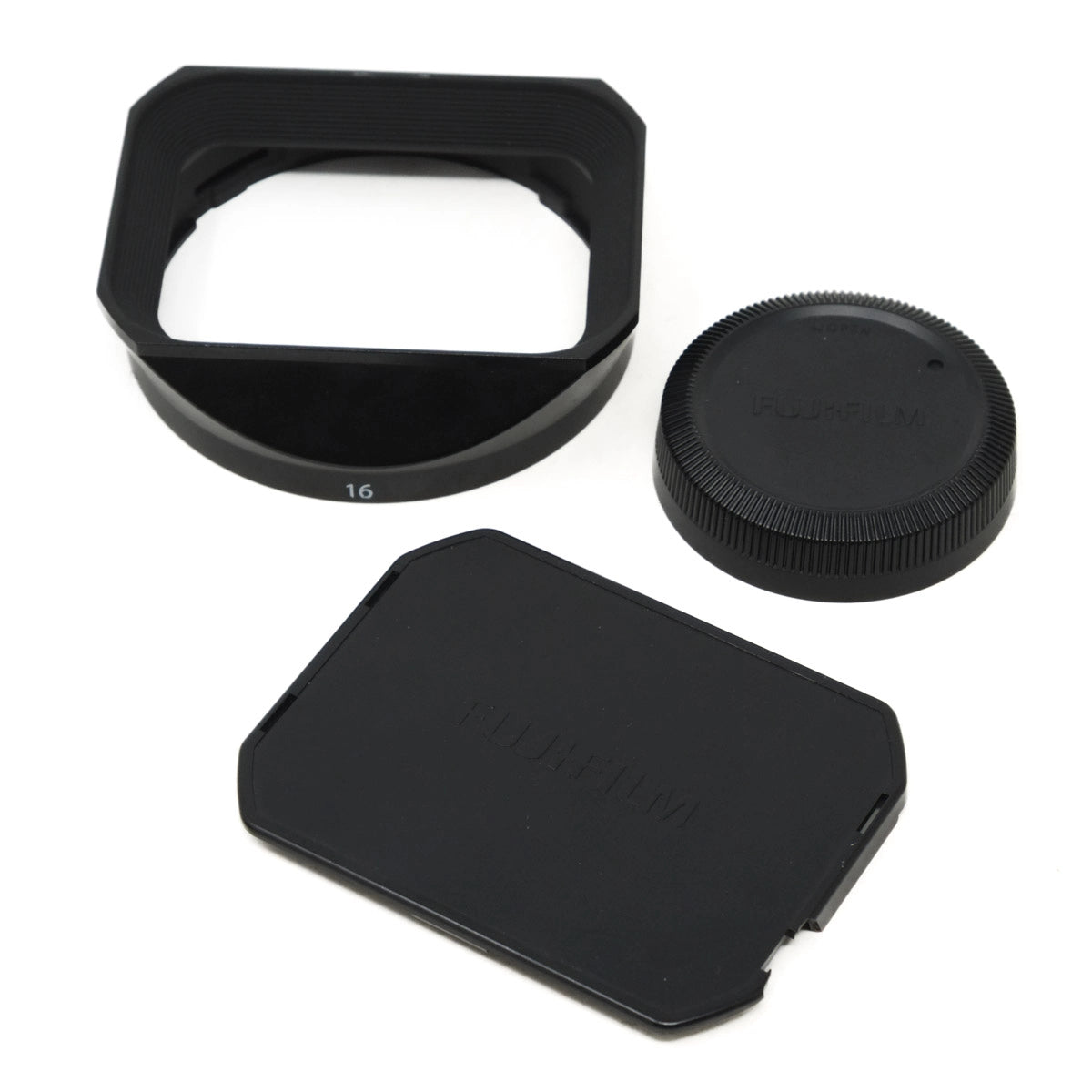 Camera lens hood, front cover, and back cap on a white background