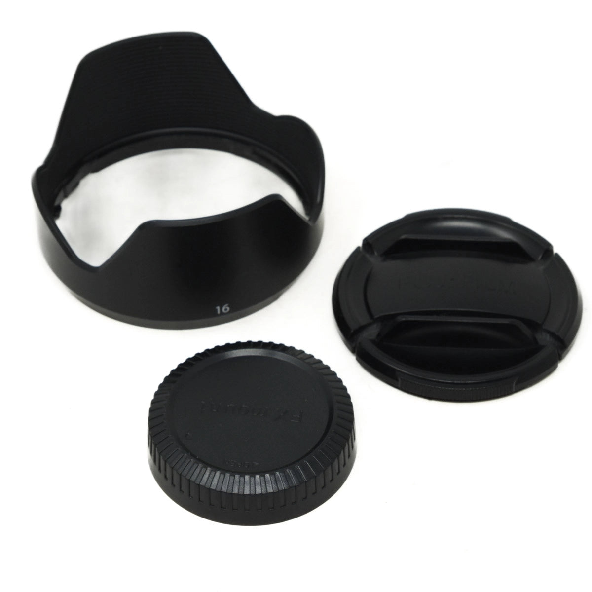 Three black camera lens accessories on a white background