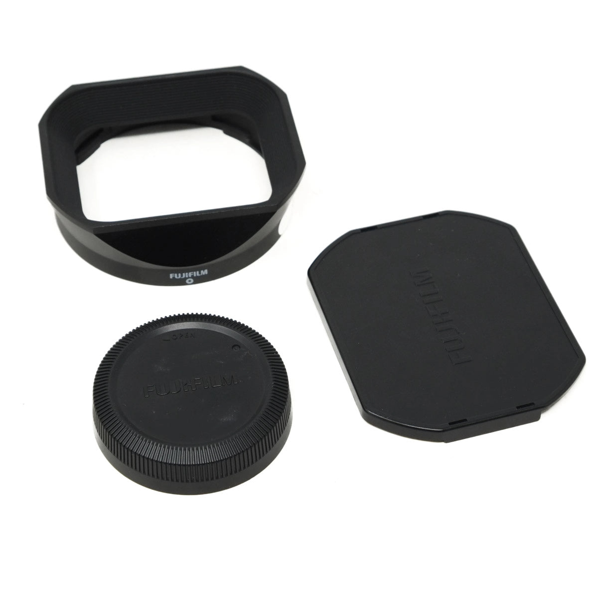 Set of Fujifilm camera lens accessories on a white background