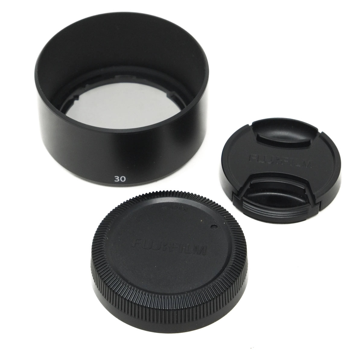 Set of black camera lens accessories on a white background