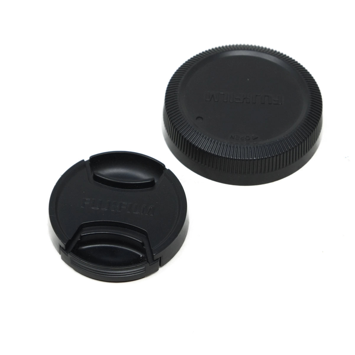 Two black camera lens caps on a white background