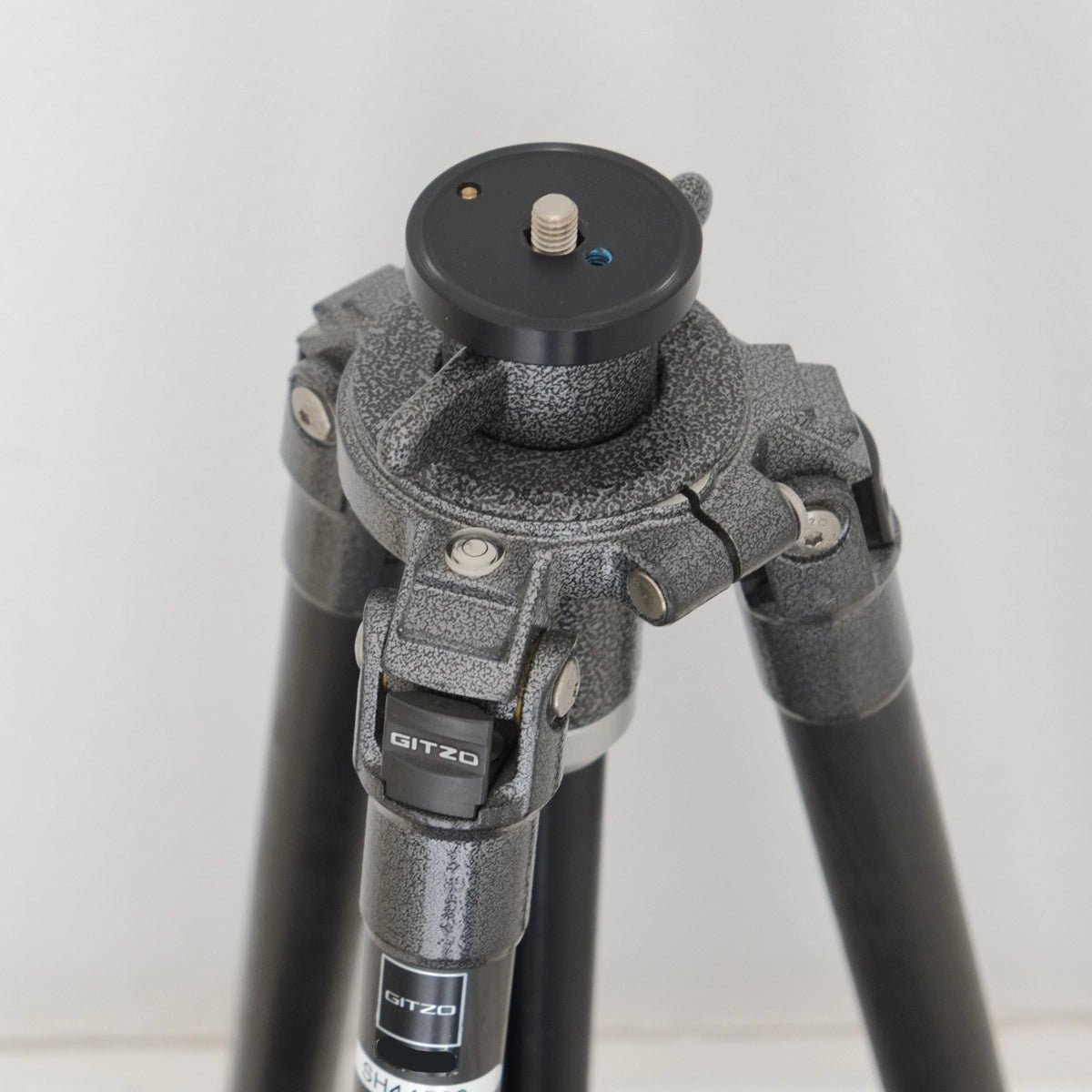 Close-up of a Gitzo tripod with a white background