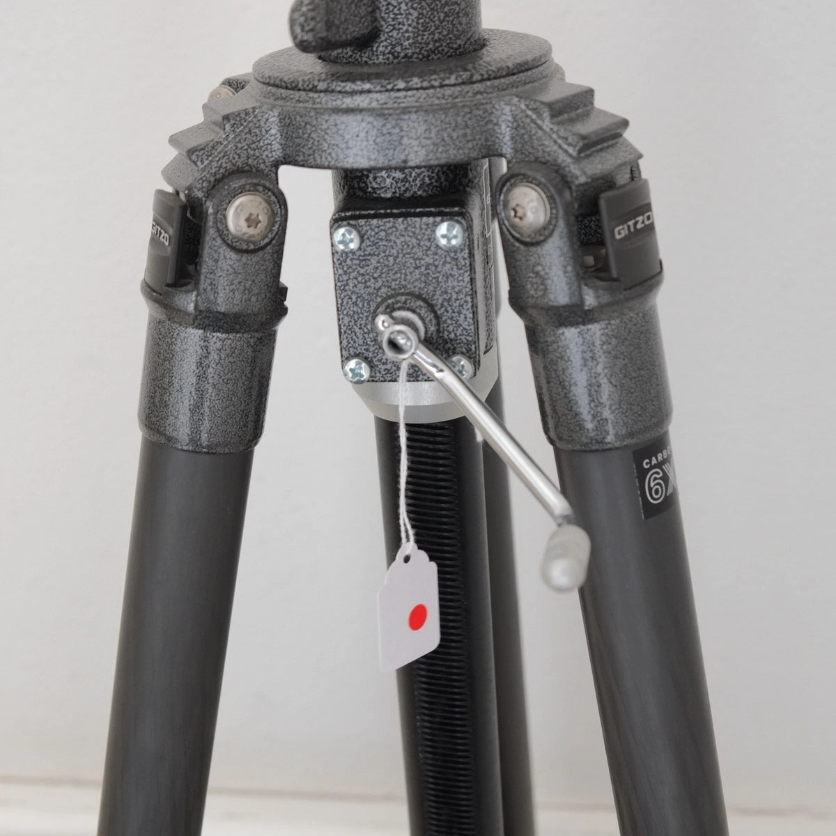Close-up of a tripod with visible brand name on a light background