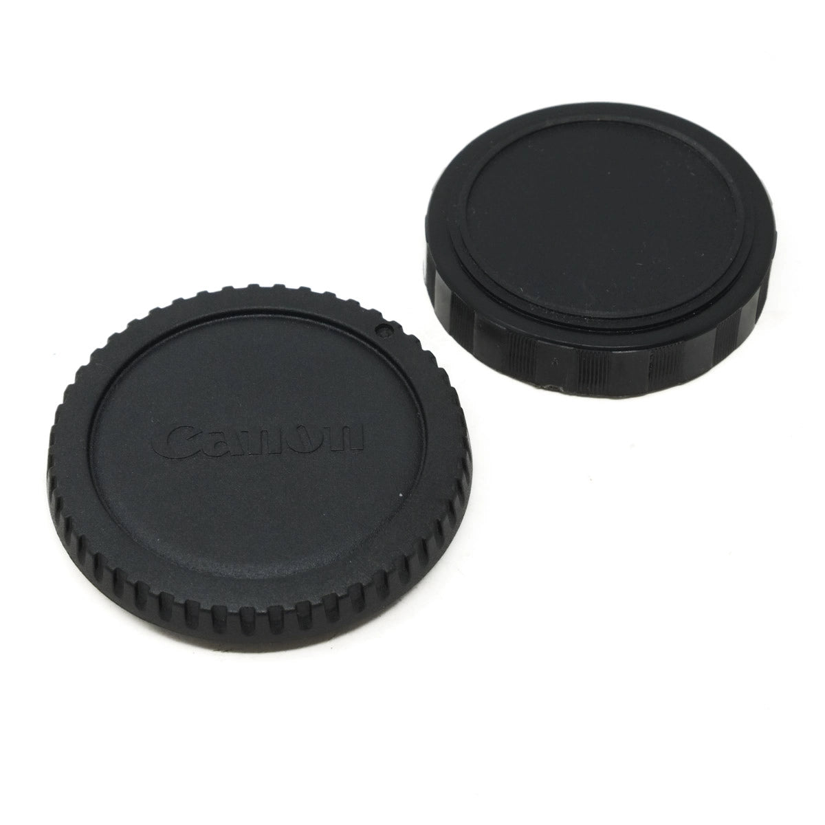 Two black camera lens caps with 'Canon' branding on a white background