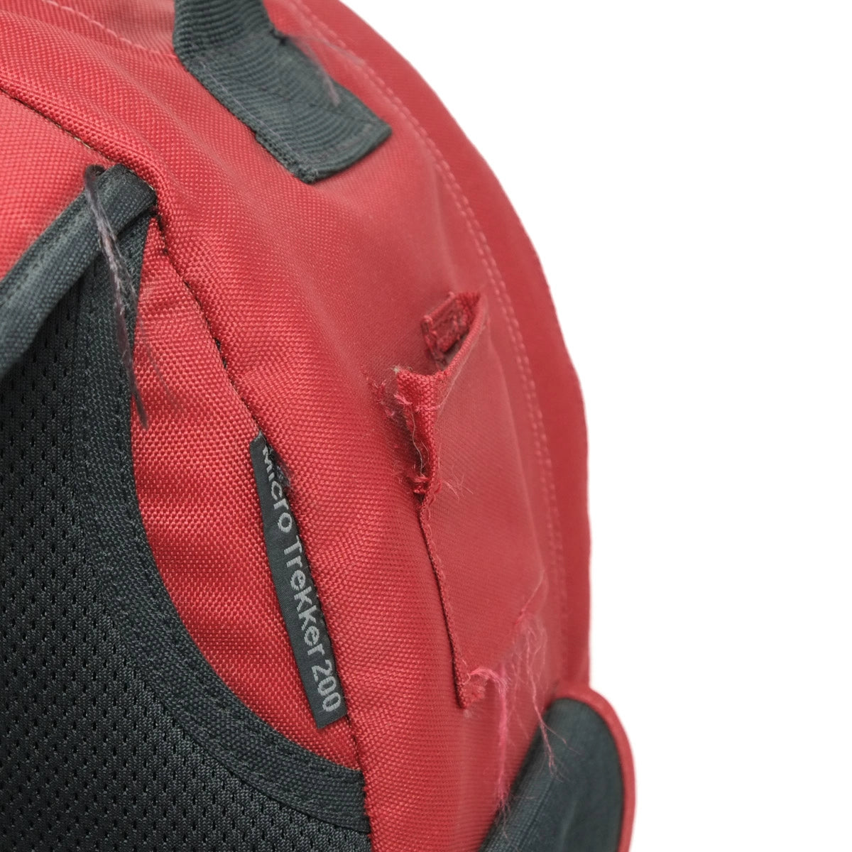 Red and black backpack with a visible brand label on a white background