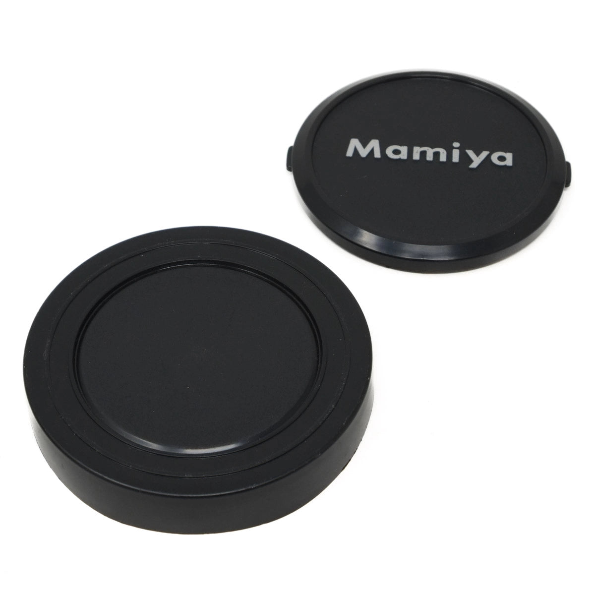 Two black camera lens caps with 'Mamiya' branding on a white background