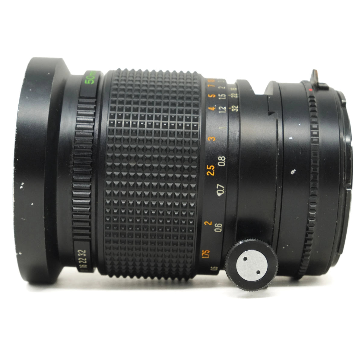 Camera lens with focus ring and control knobs on a white background