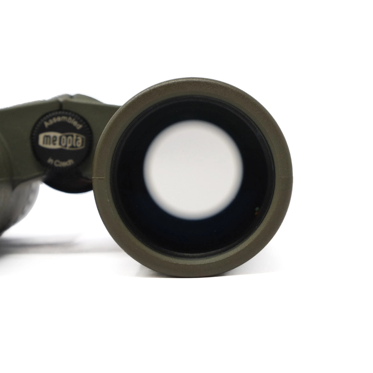Close-up of a binocular lens with 'meopta' branding on a white background